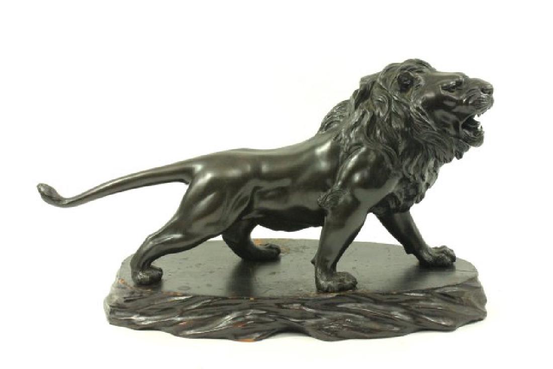 Signed Japanese Meiji Bronze Lion on Wood Base: Signed on abdomen of lion. Late 19th/early 20th century. Lion approx. 9" H x 20" L.