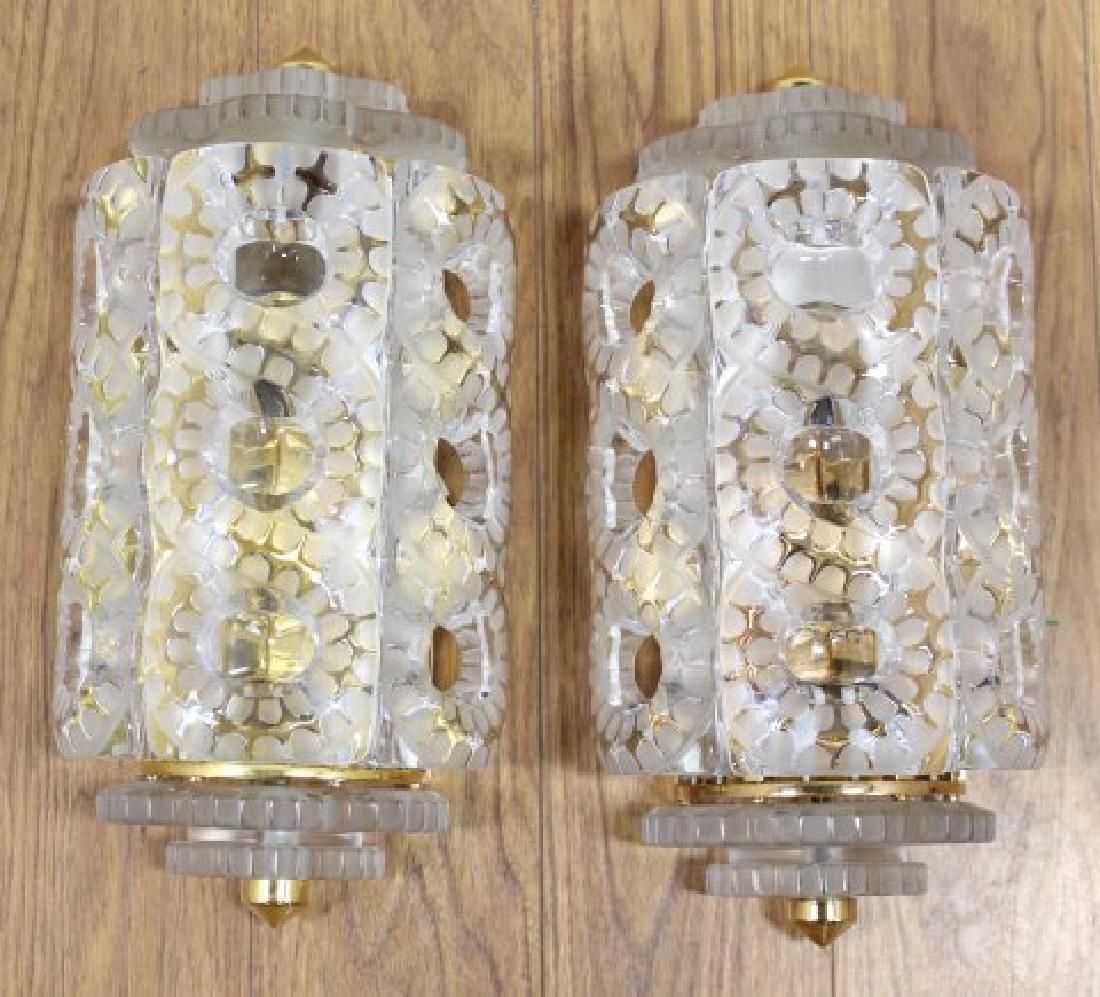 Pair Lalique Seville Sconces: Gilt bronze and frosted glass. Each etched Lalique France in script. Approx. 15 1/2" H x 7 1/4" W. Property from the Erno Laszlo Institute, West Broadway, NYC. (6191)