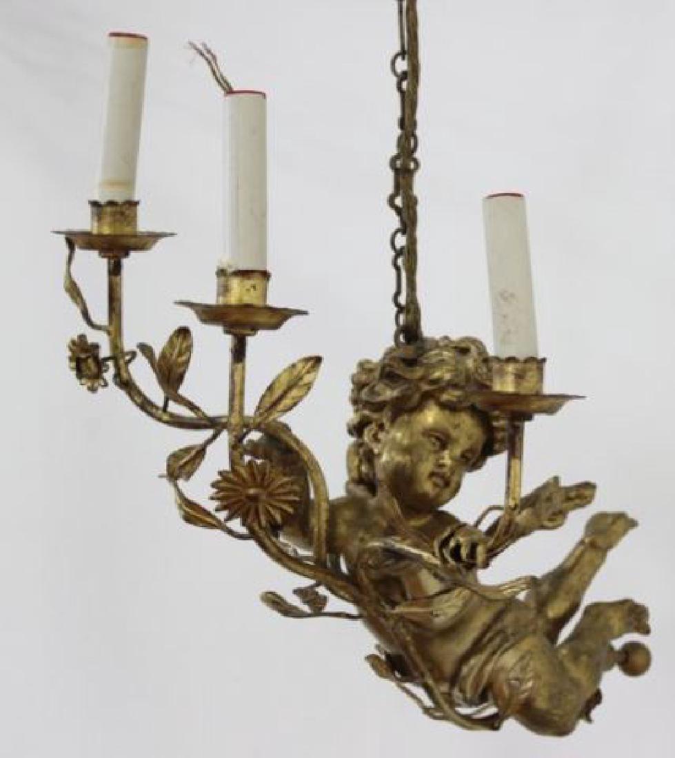 Tole & Gilt Figural Chandelier: Depicting cherub with three lights. Approx. 19" W. (6183)