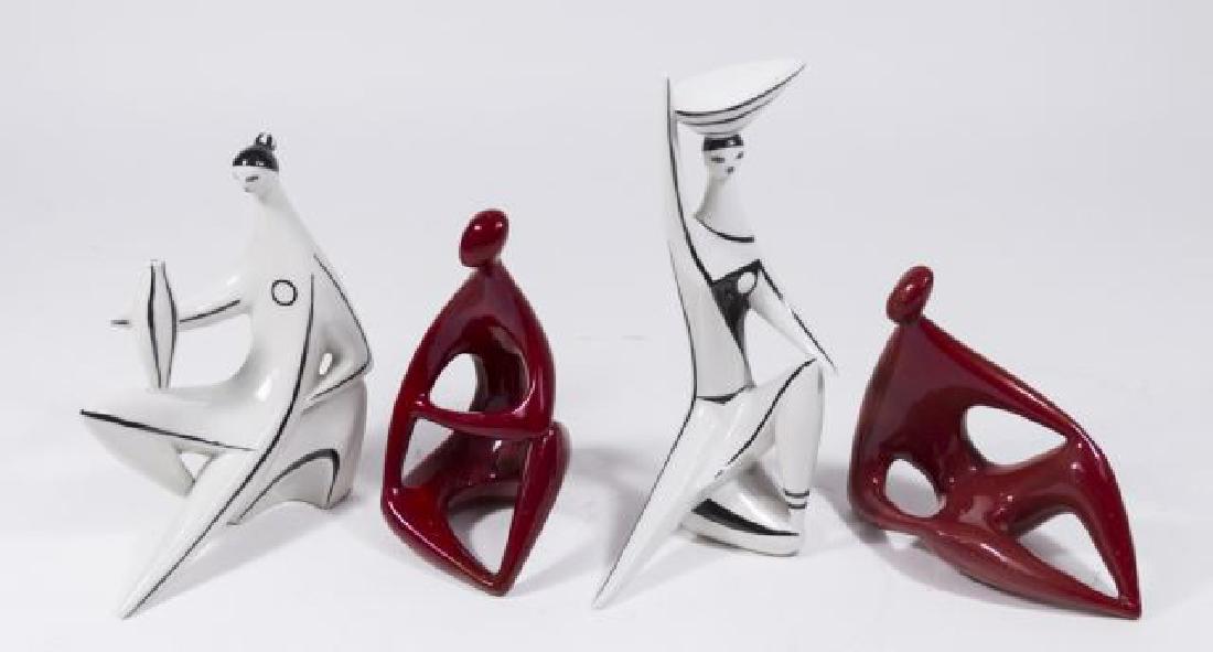 :4 Zsolnay Seated Figures: Two crimson ground, two white ground. Largest approx. 8 1/4" H. Property from the Erno Laszlo Institute, West Broadway, NYC. (6191)large white figure has nick on basket