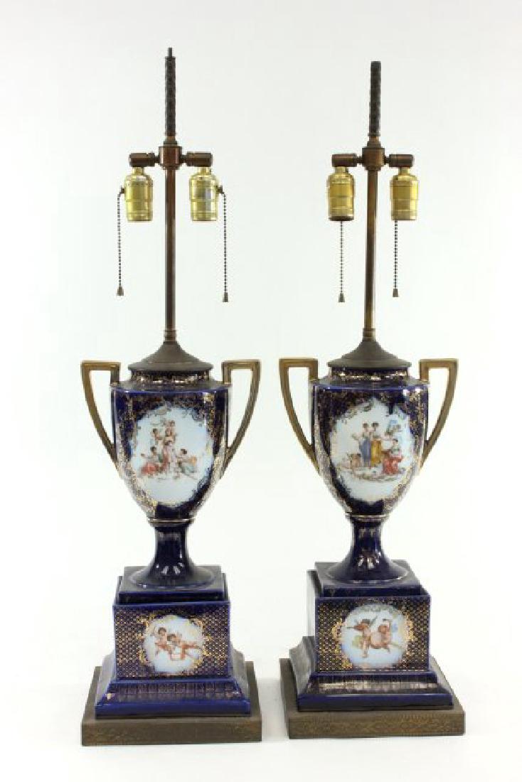 Pair Royal Vienna Style Porcelain Urns: Mounted as lamps. Painted over a transfer. Urns approx. 14 1/2" H.