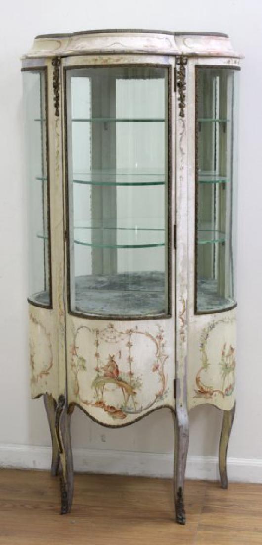 French Paint Decorated Curio: Brass mounted. Curved glass. Approx. 57" H x 24" W x 17" D. (6224) Some paint wear.