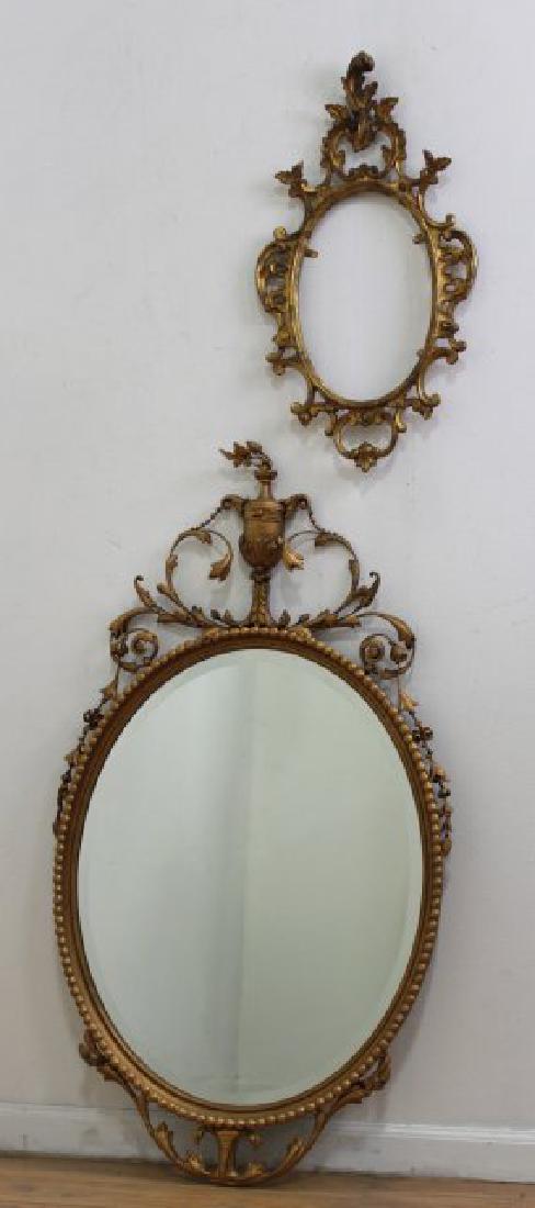 Gtilwood Oval Mirror & Gilt Oval Metal Mirror: Giltwood oval beveled mirror, with leaf, scroll, and urn design. approx. 48" H x 27" W; and gilt oval metal mirror, approx. 28 1/2" H x 15" W.