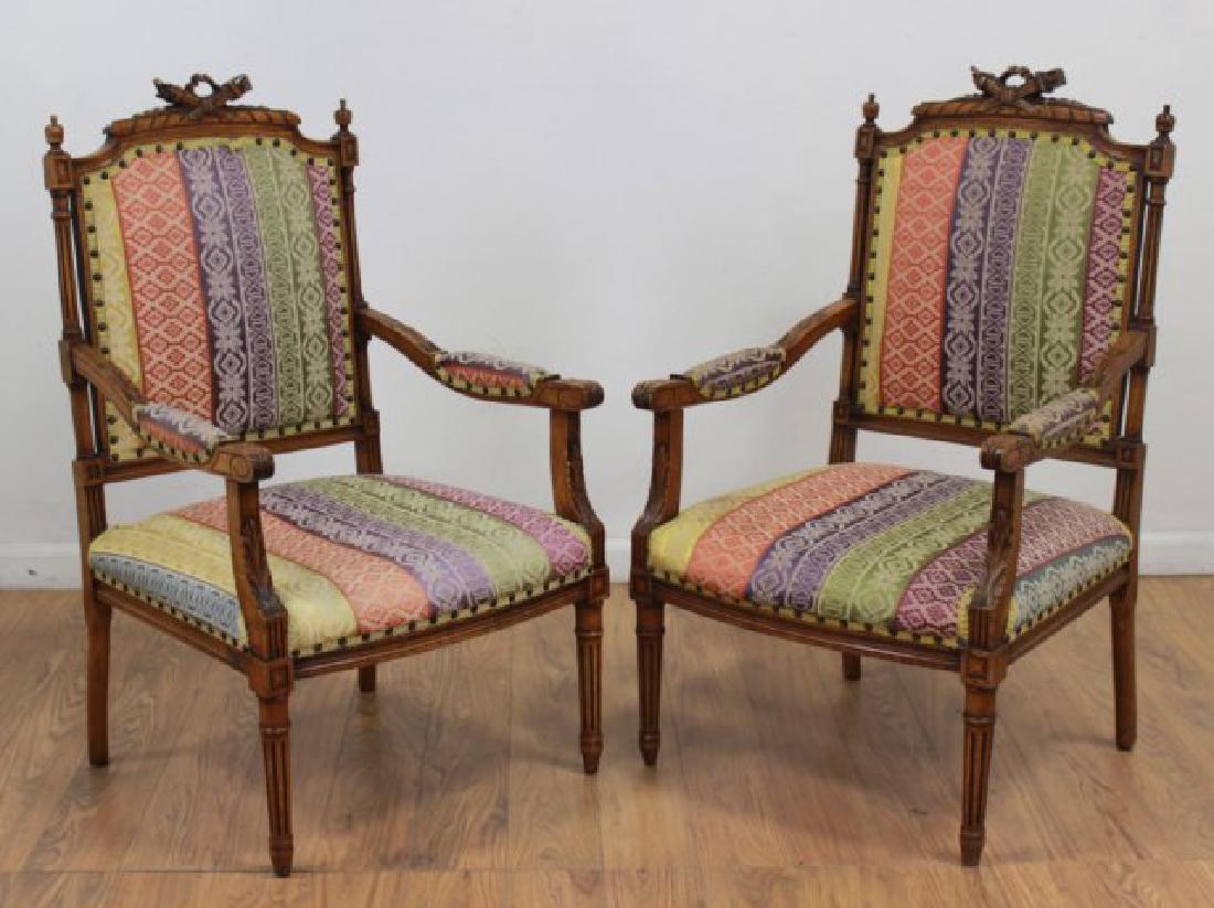 Pair French Walnut Louis XVI Style Armchairs: Torch carved backsplash. Approx. 39" H back x 20 1/2" W x 20" D.