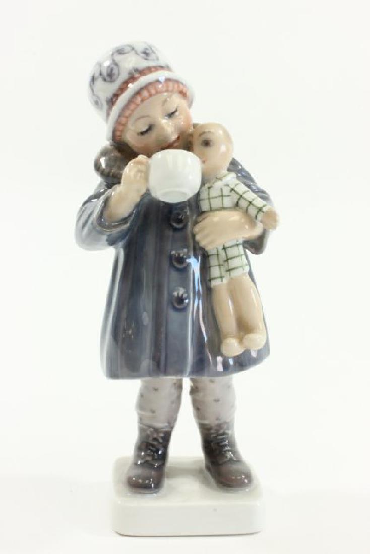 Dahl Jensen Copenhagen Figurine: #1106 girl with doll and cup. Approx. 7 1/2" H. From the estate of a NYC socialite. (7037)Good condition.