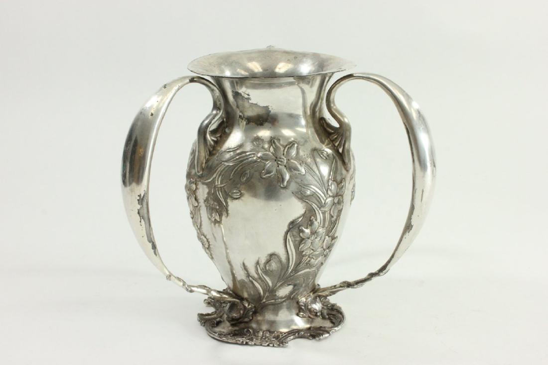 3-Handled Lun/Loving Cup: Floral repousse design. By the Middletown Silver Co. Approx. 10" H.