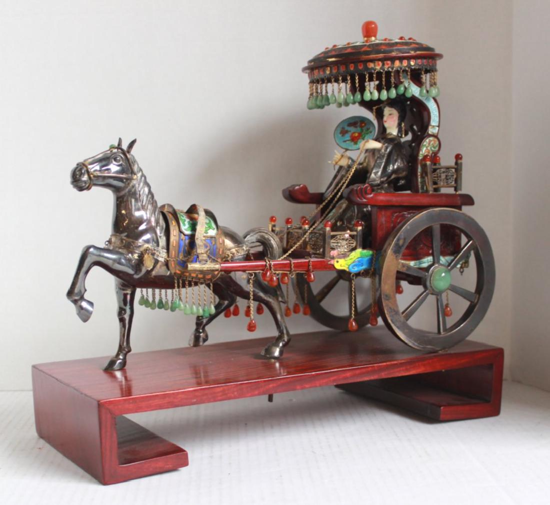 Chinese Enameled Silver & Jeweled Horse w/ Female: Horse and covered cart with female figure holding reins. Semi-precious stones. Raised on molded wood display. Second half 20th century. Approx. 7" H x 11" W x 4" D. From the estate of Ellen Dembrowski