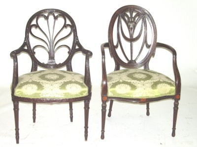 2 complimentary hand carved mahogany arm chairs