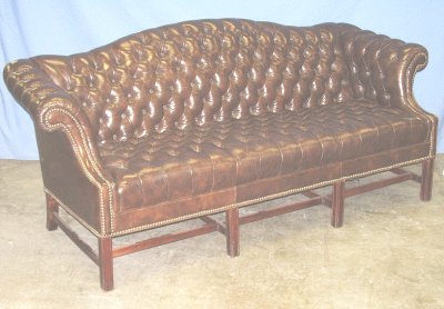 Tufted brown leather camel back sofa