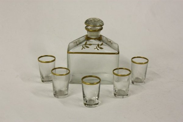 Crystal liquor set in leather box: Leather box/case is gold tooled. 1 bottle & 5 glasses.