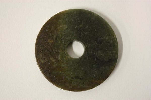 Flat brown soapstone: With design. Approx. 3.5" Diam.