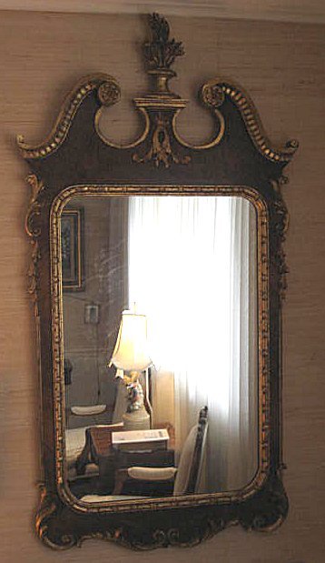 George III style mahogany mirror: With giltwood highlights. Approx. 54.5" H x 28.25". From the Palmetto Estate of Dorothy Martin.