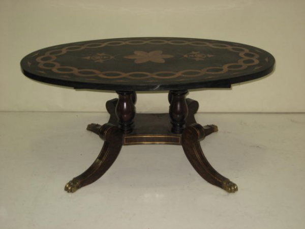 Marble coffee table with gold stone inlay: Oval, on brass inlaid claw foot rosewood Duncan Phyfe base. Approx. 44" x 29.75" x 19.5" H