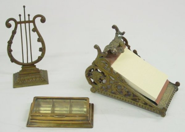 Group lot assorted smalls: Includes: 1-19th c. bronze J.C. Konig & Ebhardt, Hanover German memo pad holder depicting griffon open scroll work, 1-brass musical pen holder rack & 1-brass stamp box with bevelled glass lid.