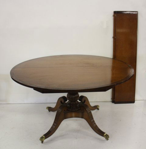 Duncan Phyfe dining room table ca. 1940's: With bronze claw feet, 1" rosewood banding & 2-12" leaves. Approx. 54" Diam.