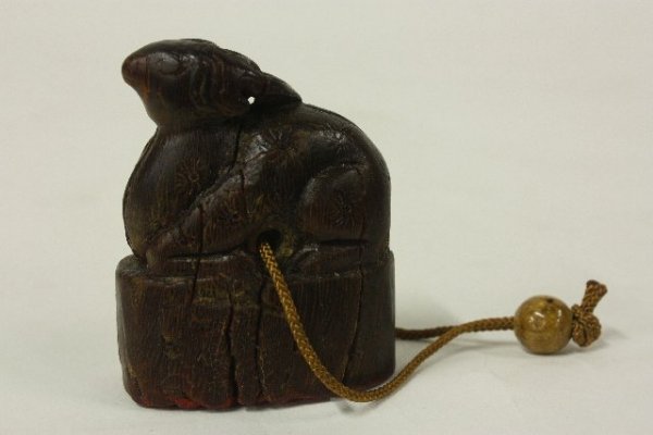 17th c. carved cinnabar & wood seal: Seal depicts rhinoceros. Carved wood is on string with stone bull.