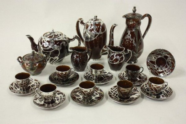 Group lot assorted silver overlay pottery Include: By Lenox. Includes: 6 cups, 9 saucers, coffee pot & creamer all in good condition. Also included creamer, 2 cups, 2 teapots & sugar some cracks.