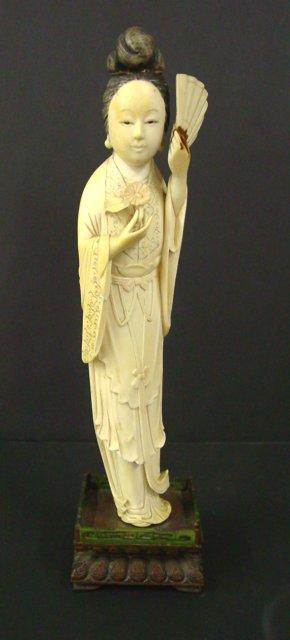 Ivory carving "Woman Holding Flower & Fan" : Approx. 10" H without stand, 11.5" H with stand. From the estate of an anonymous Orientalia collector in Edison, New Jersey.