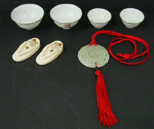 Group lot assorted Oriental smalls: Includes: Jade carved pendant, pair bone thong shoes, 4 floral decorated sake cups signed. From the estate of an anonymous Orientalia collector in Edison, New Jersey.