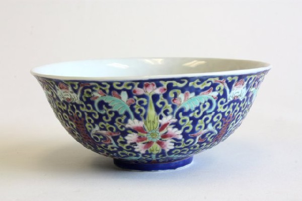 Antique Chinese bowl with Guangxu mark: Guangxu mark and period. Handpainted porcelain with bats, shou, and scrolling lotus on dark blue ground. Approx. 6.5" Diam.
