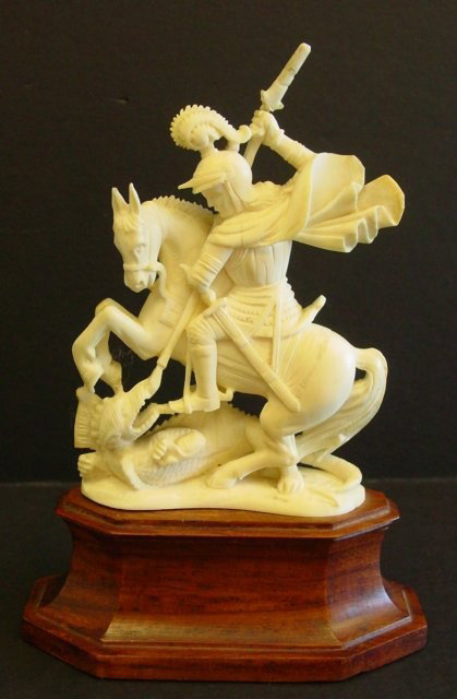 European ivory" St. George Slaying the Dragon". : "St. George Slaying the Dragon". Mounted on wood base. Repairs on sword. Figure approx. 4" H, Base Approx. 1.25" H.