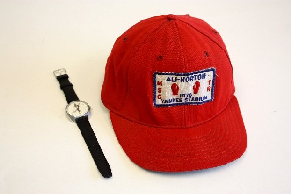 Group lot of assorted Muhammad Ali Memorabilia: Includes: 1976 baseball cap & Swiss made "DePraz" watch with image of Muhammad Ali on face. (Approved by Ali, however never marketed). Wind up, working.