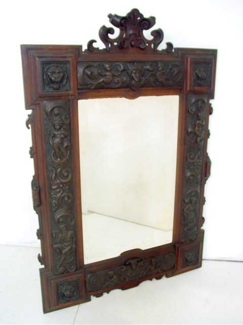 Carved figural mirror: With Lion's heads, Putti & King with Crown. Approx. 62" H x 42.5" W.