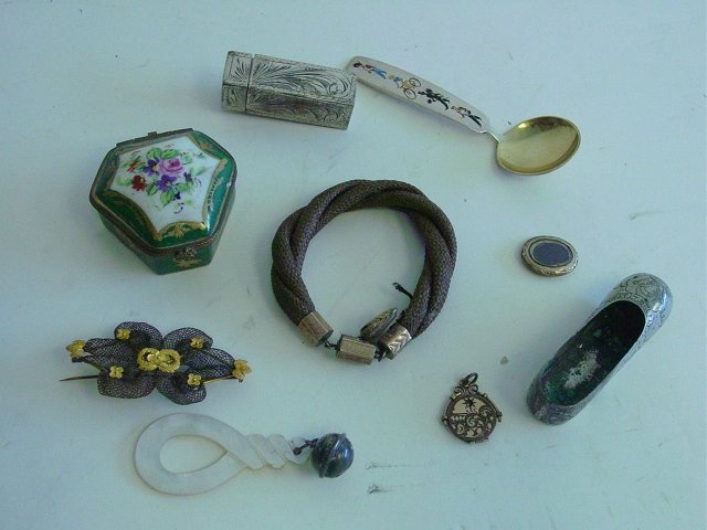 Group lot of asorted smalls & jewelry: Includes: mourning pins & necklace, silver shor, silver lipstick, small porcelain French pill box, mother of pearl & silver rattle, Michelsen, Denmark enamelled spoon.