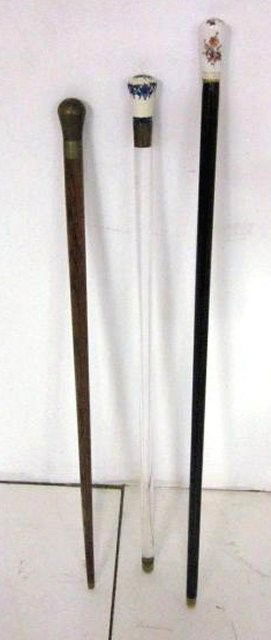 3 canes: 2 with porcelain handle. 1 with silver mount. One cane is lucite. From the estate of Carl Freed of K. Gluck Selig Antiques, mid-town Manhattan dealer.