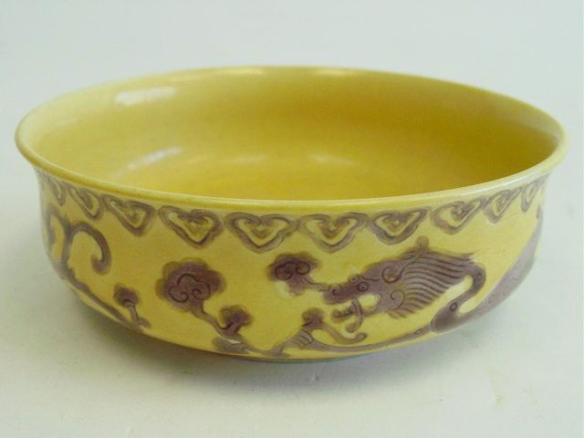 Yellow pottery bowl with "Dragons": Approx. 5 3/4"Diam. x 1 3/4"H