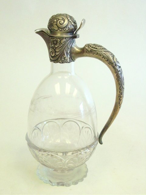 American crystal & silver pitcher by Starr: Stamped Theo B. Starr. With scrolled silver handle and lid, inscribed under lip 1871-1896 with initials, sterling. Chip on base. Approx. 11" H. Please read our terms of sale.