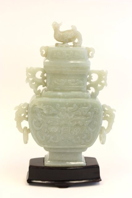 Chinese carved jade covered urn: Carvings on face and carved chicken on top, mounted on wood base, approx. 9.5" H. Please read our terms of sale.