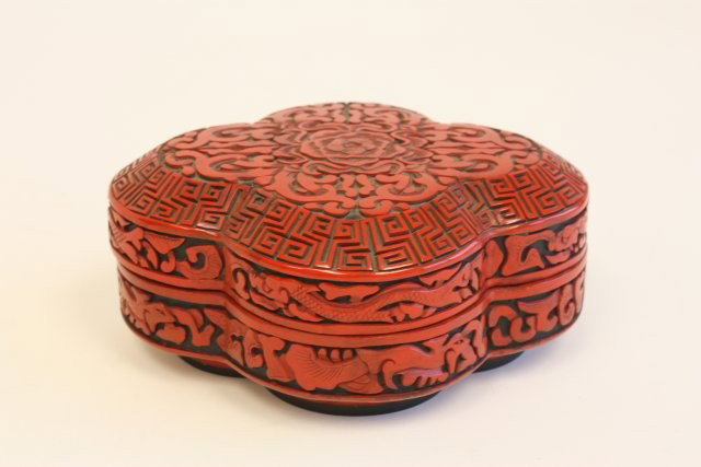 Red cinnabar covered box: Approx. 6" x 5" x 2.25". Madam Hengyi Aixinjueluo is a well-known Chinese artist. She is a descendant of the royal family of the Qing Dynasty, she is the grand niece of the last Emperor of China; she