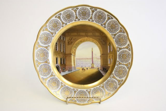 Russian Imperial porcelain factory plate: White & gold, made during the reign of Nicholas I, "View of Winter Palace and Colaud of Alexander I in St. Petersburg", dated 1844 and signed by painter V. Stoleton on the back, Nicholas I blue mark. 