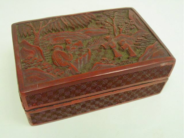 Early 20th c. Chinese cinnabar lacquer box: Rectangular, with carved figures, age wearing. The interior and base are plain black lacquer. Approx. 5.5" x 3.75" x 2.25". Please read our terms of sale.