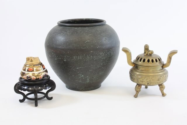 Group lot of assorted smalls: 1- Bronze censer, approx. 7" x 7". 1- Bronze bowl, approx. 9" H x 11" Diam. 1- Teakwood stand. 1- Royal Crown Derby lighter. Please read our terms of sale.