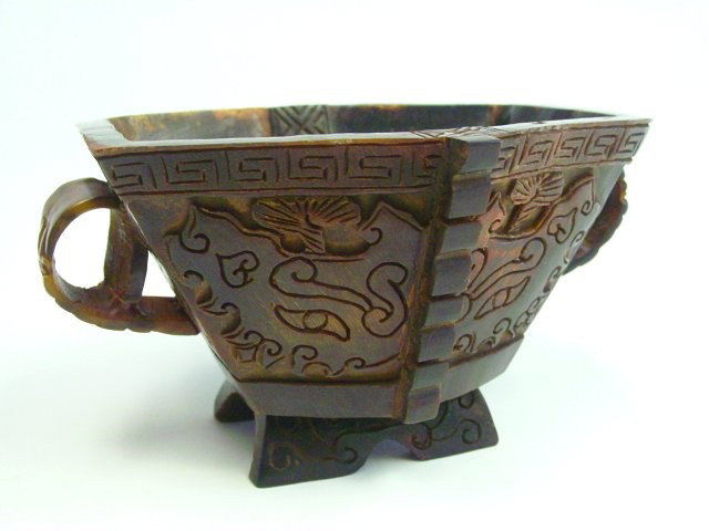2 handled bone cup with cameo carved design: 6 sided. Approx. 5.5" x 4.5" x 3" H. Please read our terms of sale.