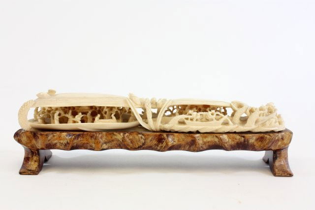 Fabulous quality heavily carved Chinese ivory: Depicting "Village Scene; Fishing". Surounded by vegetation. Approx. 8" W x 1.25" H, Pedestal approx. 1.5" H Please read our terms of sale.