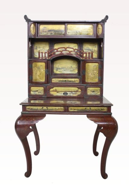 19th c. lacquered Japanese ladies writing desk: With panelled superstructure, sliding doors above an open section with central bridge above dome, top large cubby hole flanked by 2 cupboard doors above a shallow drawer, all mounted above a freeze wi