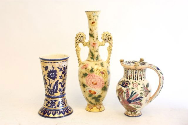 Lot 3 Zsolnay pieces: Including: 1- Blue & gold vase, approx. 8" H. 1- 2 handled yellow vase with flowers, approx. 14" H, old restoration. 1- 1 handled vase with flowers, approx. 7.75" H, some restoration. Please read our