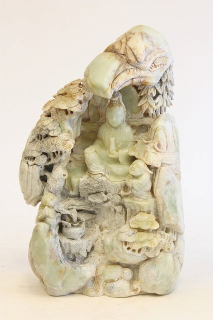 Jade carving of "Guan Yin": "Guan Yin in a Boulder under Pon Trees". Approx. 18.5" H x 11.5" W. Please read our terms of sale.