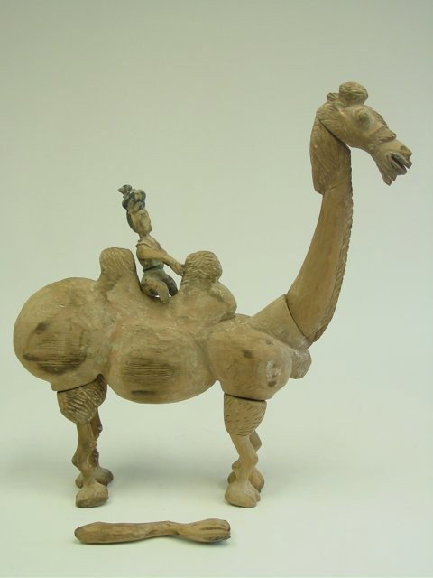 Carved wood "Man on Camel": Possibly Han Dynasty. Losses to man's foot. Approx. 22.5" H x 21" W. From a 40 year collection. Please read our terms of sale.