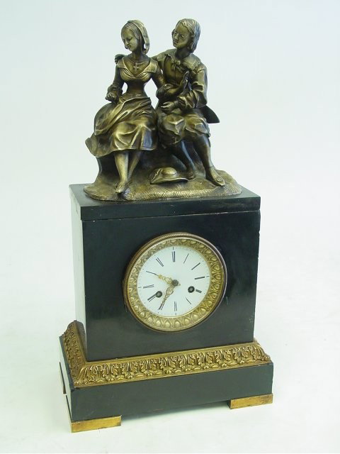 French marble & bronze 19th c. figural clock: Depicting "Courting Scene", black marble, dore bronze, bracket bronze feet. Approx 19" H x 10.25" across. Please read our terms of sale.