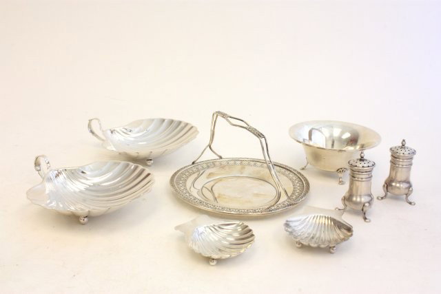 Group lot sterling silver: Including: 2- pair shell dishes. 1- basket. 1- Footed bowl. 1- Pair salt & pepper. Approx. 14 oz. Property of retired Judge Susan Perretti Benson. Please read our terms of sale.