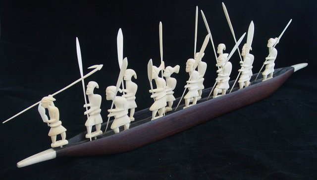 African carving of ivory & wood: "13 Ivory Warriors in Wood & Ivory Boat". Approx. 7.5" H (spear height) x 24" across Please read our terms of sale.