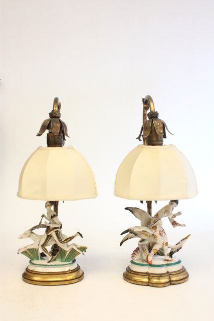Pair Art Deco boudoir lamps: Depicting "Porcelain Girl with Ram", "Girl with Bird", silk shades, bronze bases, fingers missing on both. Approx. 15" x 6". Please read our terms of sale.
