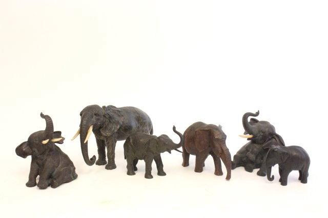 Group lot of 6 elephants: Includes: 1-7" H x 10" W bronze elephant with ivory tusks, stamped Geschutz (chip on tusk). 1-4" x 7" wood carved elephant. 1-6.75" H pair seated bronze elephants with iory tusks, chinese stamp on bot