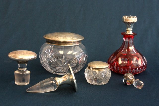 Group lot assorted jars, dabbers & perfumer: Includes: 2 sterling silver top jars, 3 odd silver & glass dabbers & 1 red cut to clear perfumer with silver top. Property of retired Judge Susan Perretti Benson. Please read our terms of sale.