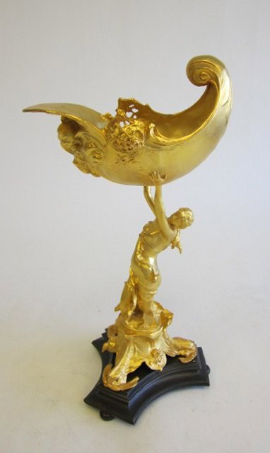 Dore bronze centerpiece: Depicting "Woman Holding Scrolled Shell". Approx. 15.5" H. Please read our terms of sale.