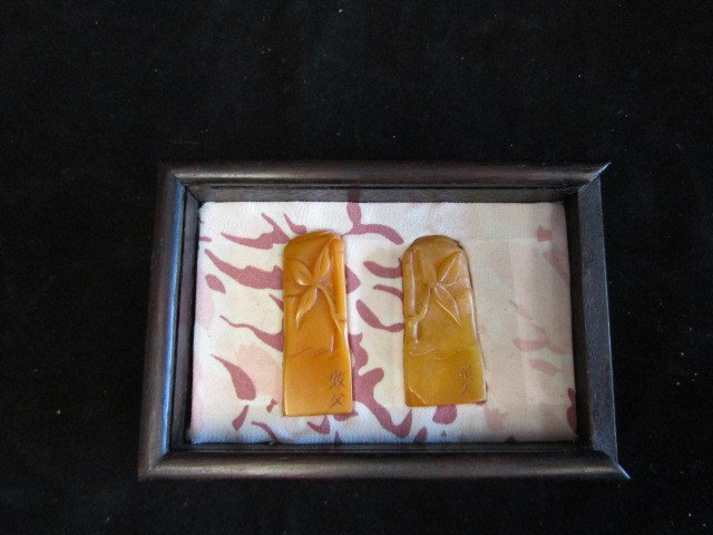 2 carved soapstone stamps in wooden box: Each is 2" H. Please read our terms of sale.